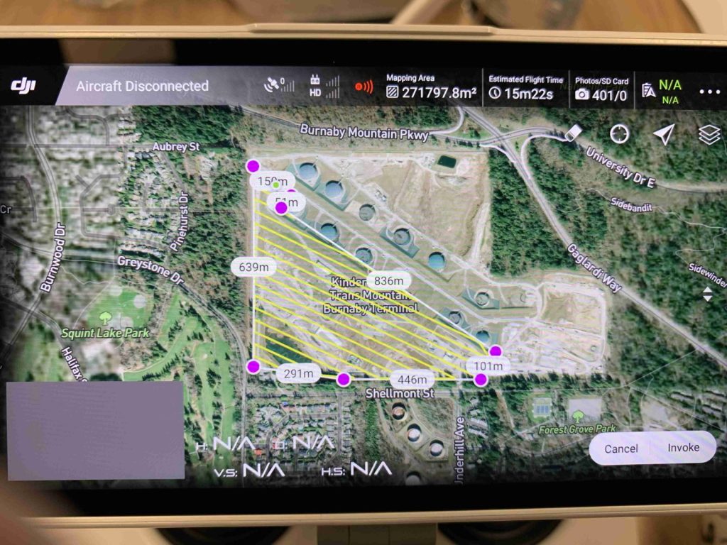 Satellite map of a storage/terminal site with yellow diagonal hazard lines and pink markers, labeled Kinder Trans Mountain Burnaby Terminal near Burnaby Mountain Pkwy, showing measurements (in meters).